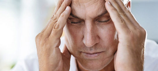 man holding head